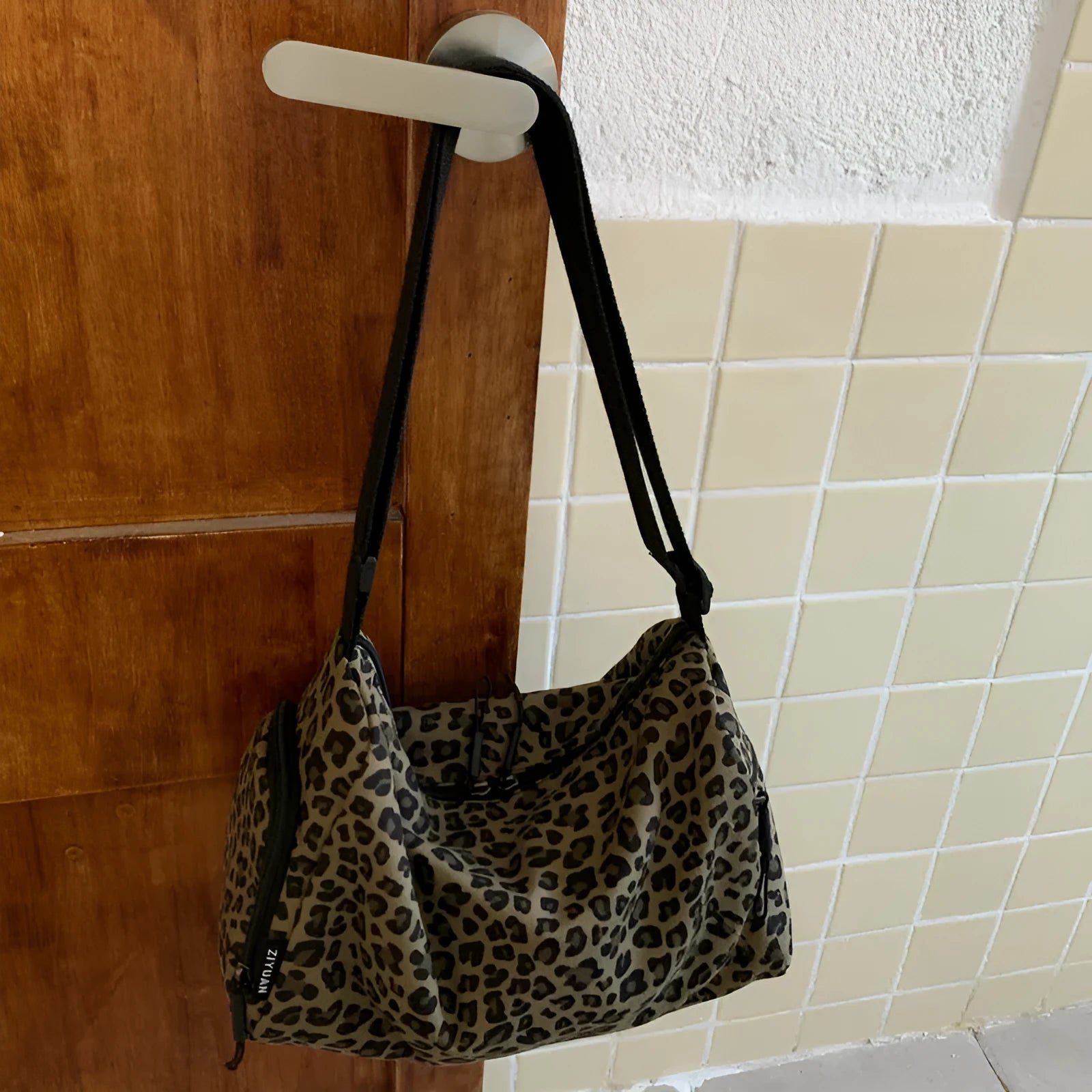 Unisex leopard print messenger bag with striped pattern, crossbody shoulder design