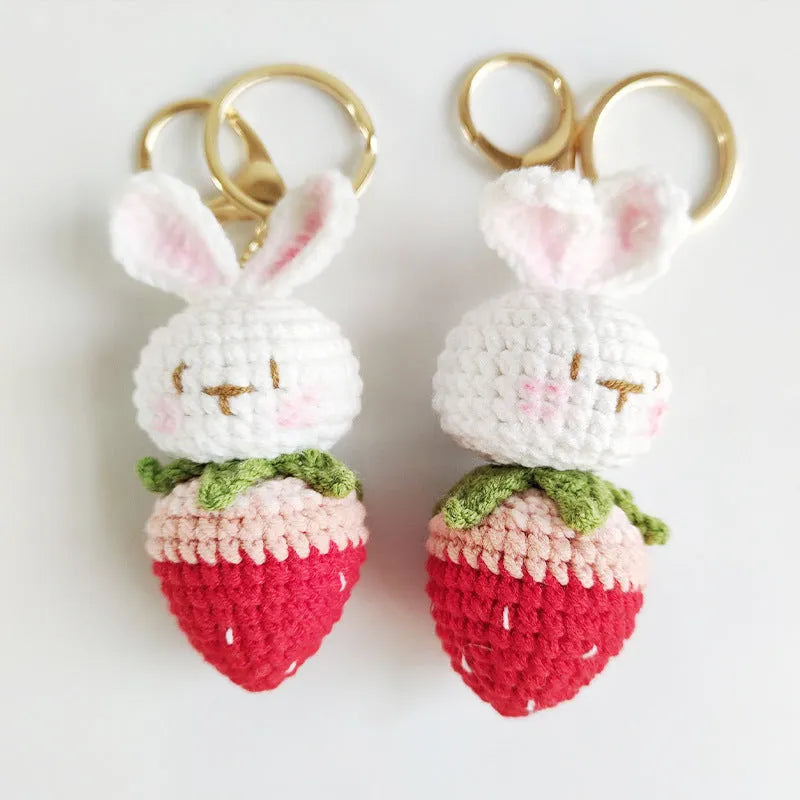 White hand-woven rabbit strawberry pendant with cartoon design and attached key on four-strand doll wire