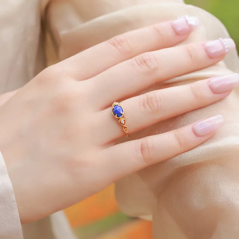 Elliptical lapis lazuli ring with sterling silver setting showing geometric design and natural stone colour variations