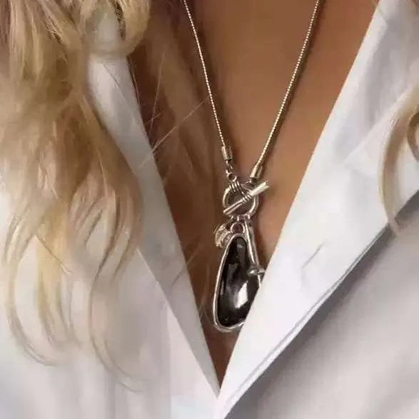 Long geometric alloy pendant necklace with snake bones chain for layering over jumpers