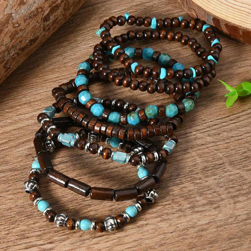 Seven multicolour retro bracelets with round wooden beads and alloy details laid out flat.