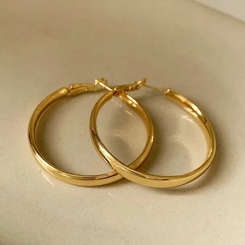 Pair of 40mm diameter circle earrings with electroplated gold or silver finish on copper