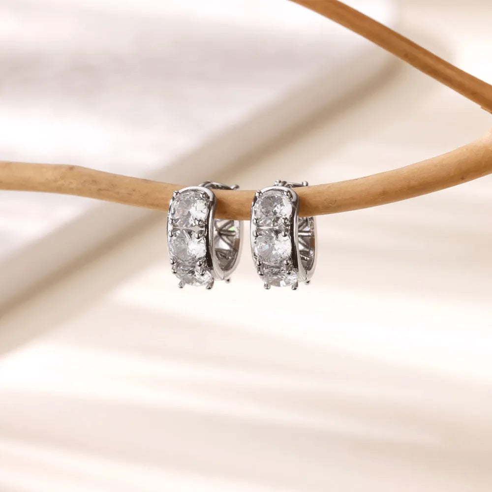 Women's U-shaped clip earrings with zircon inlays on stainless steel, showing alloy clip mechanism