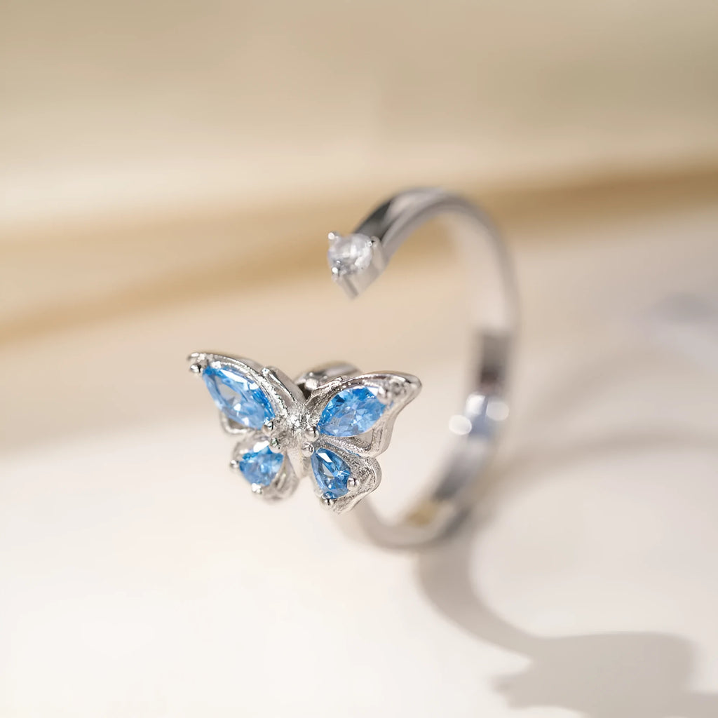 Adjustable butterfly ring in electroplated copper, available in white gold or yellow gold with blue or pink diamond finish
