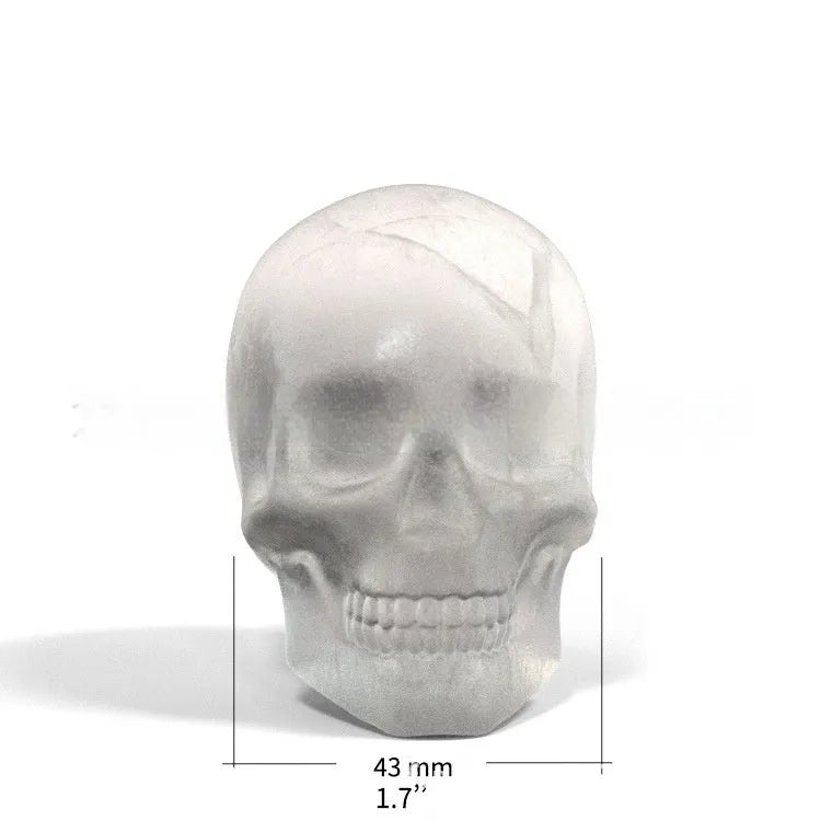 3D Halloween skull ice cube tray made from blue food-grade silicone, showing detailed mould cavities.