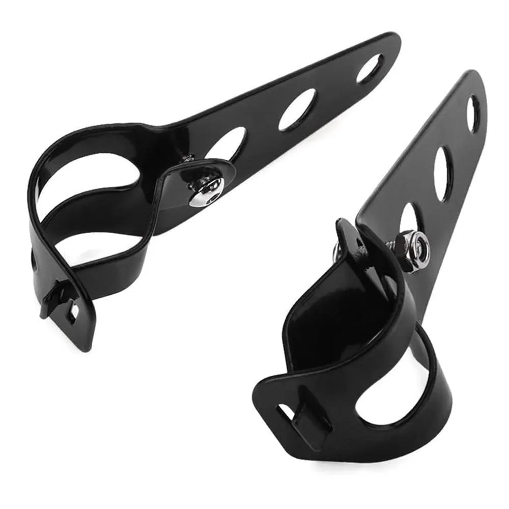 A pair of black iron motorcycle headlamp support brackets for retro modification.