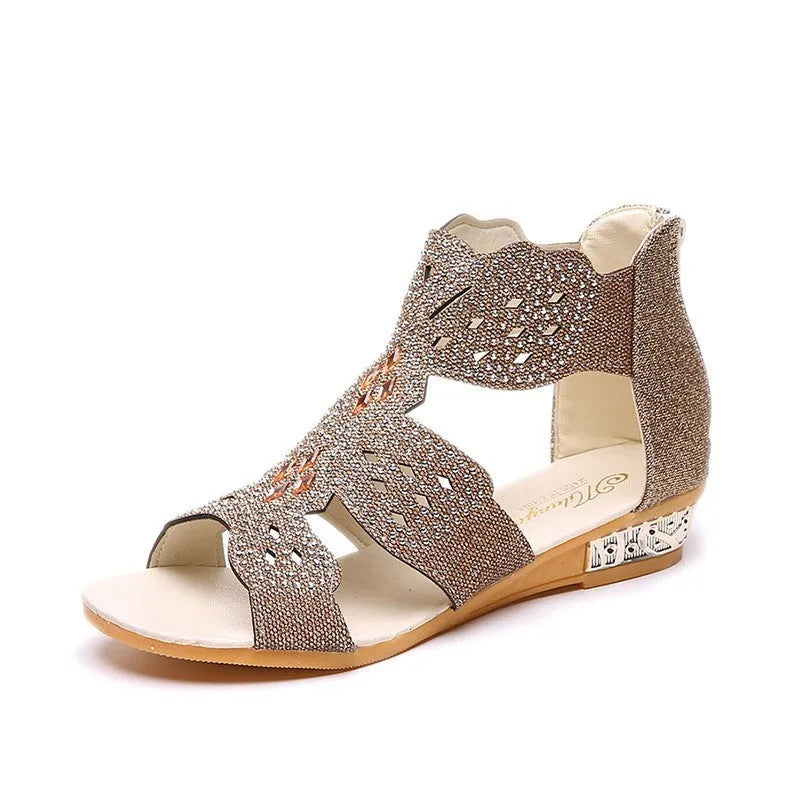 Women's beige open toe sandals with rhinestone detail and a back zipper on a flat rubber sole.