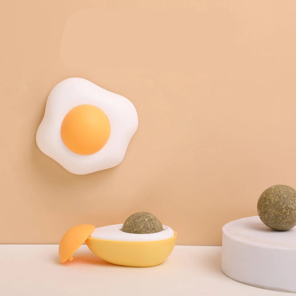 Catnip ball toy with 360-degree rotation mounted on wall, natural catnip filling visible through plush material