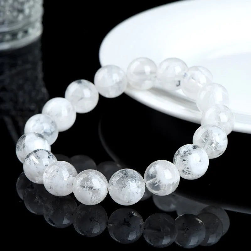 Women's crystal bracelet with round geometric beads in blizzard colour, showing Ruyi and Xiangyun design motifs.
