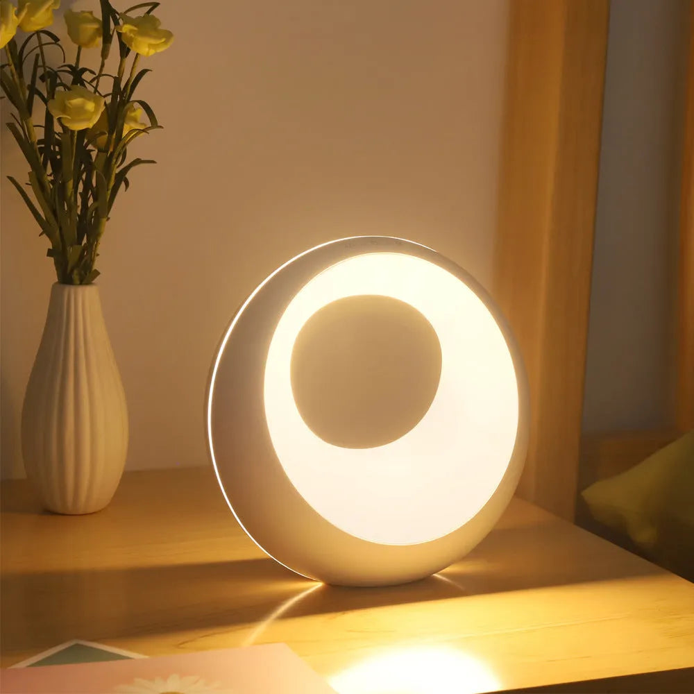 Small RGB colour changing night lamp with remote control on wooden desk