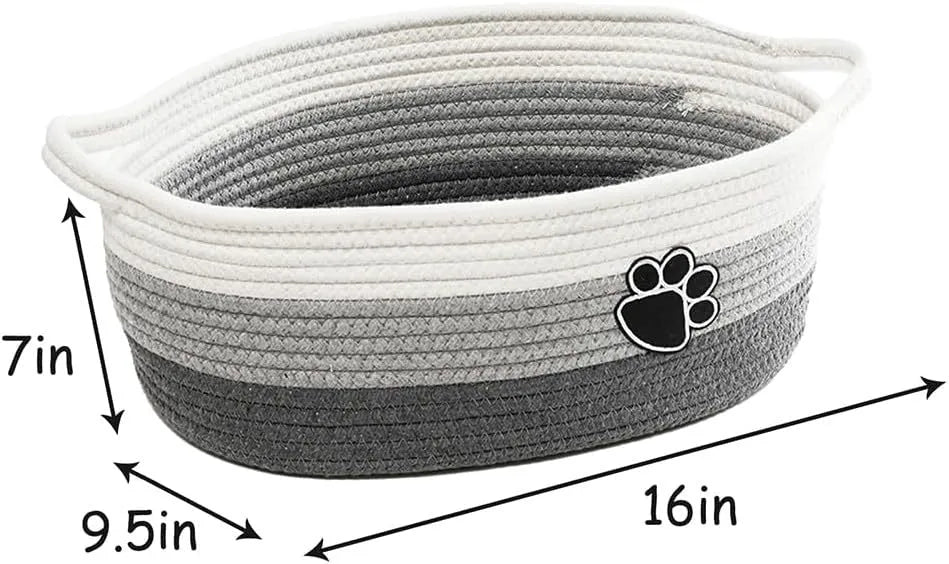 Small woven cotton rope storage basket with wooden handle in light beige, measuring 34x26x15cm, on a shelf with toys