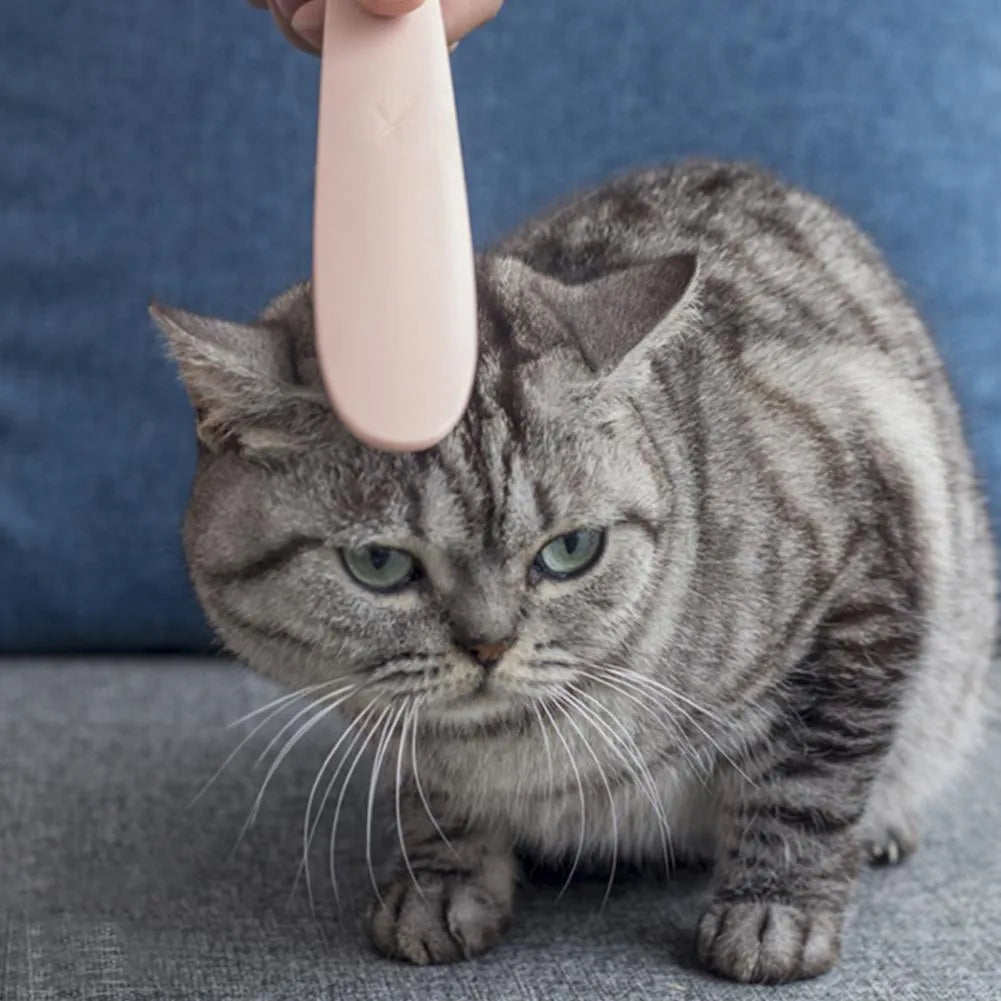 Grey and pink ABS cat grooming comb with tongue massager design and dual-width ends for pet hair removal