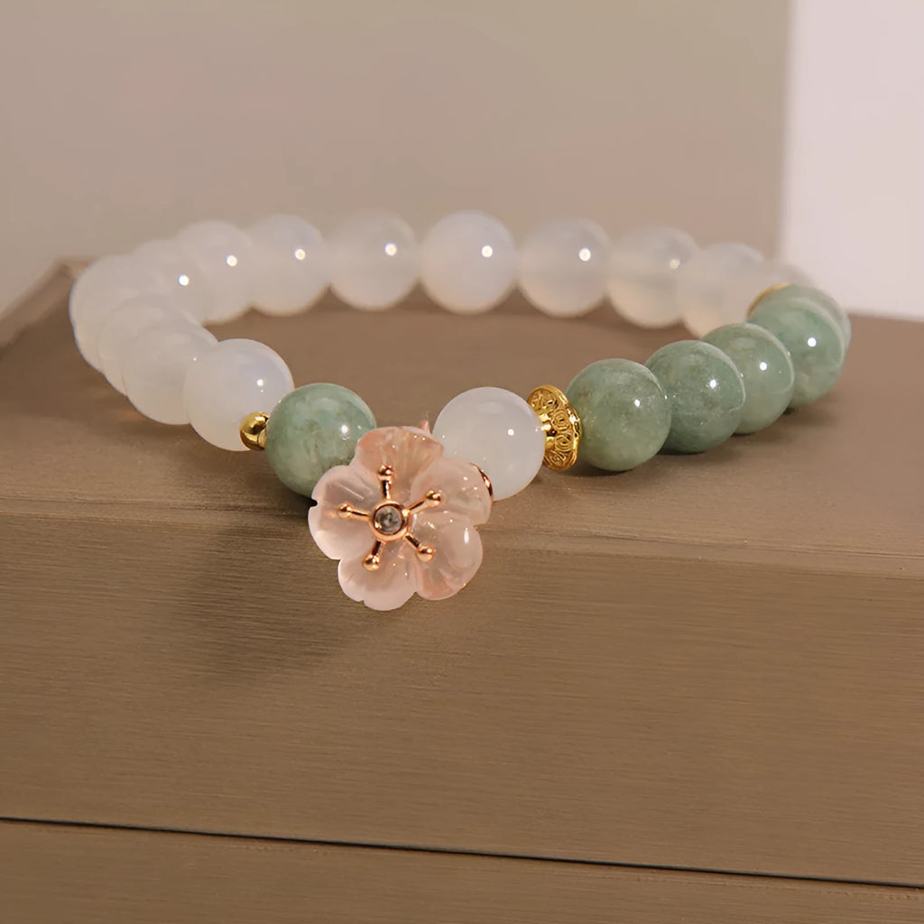 White agate jade bracelet with pink floral detailing and adjustable fastening