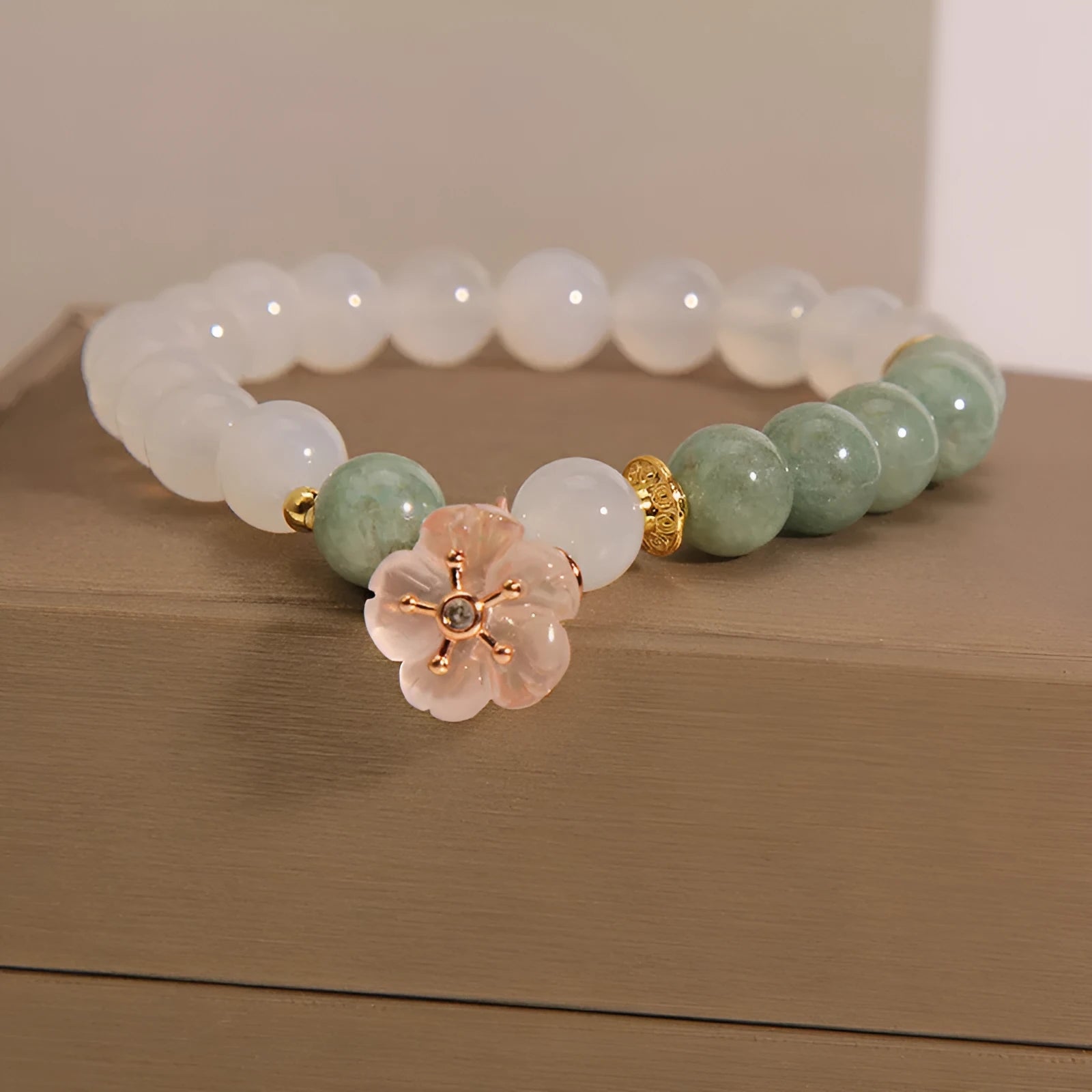 White agate jade bracelet with pink floral detailing and adjustable fastening