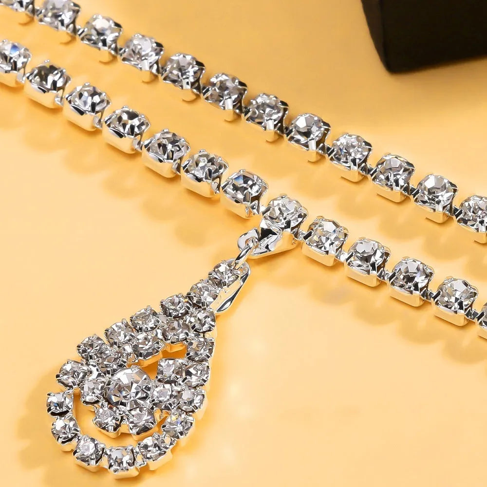 Gold adjustable waist chain with rhinestone water drop pendant and lobster clasp on mannequin