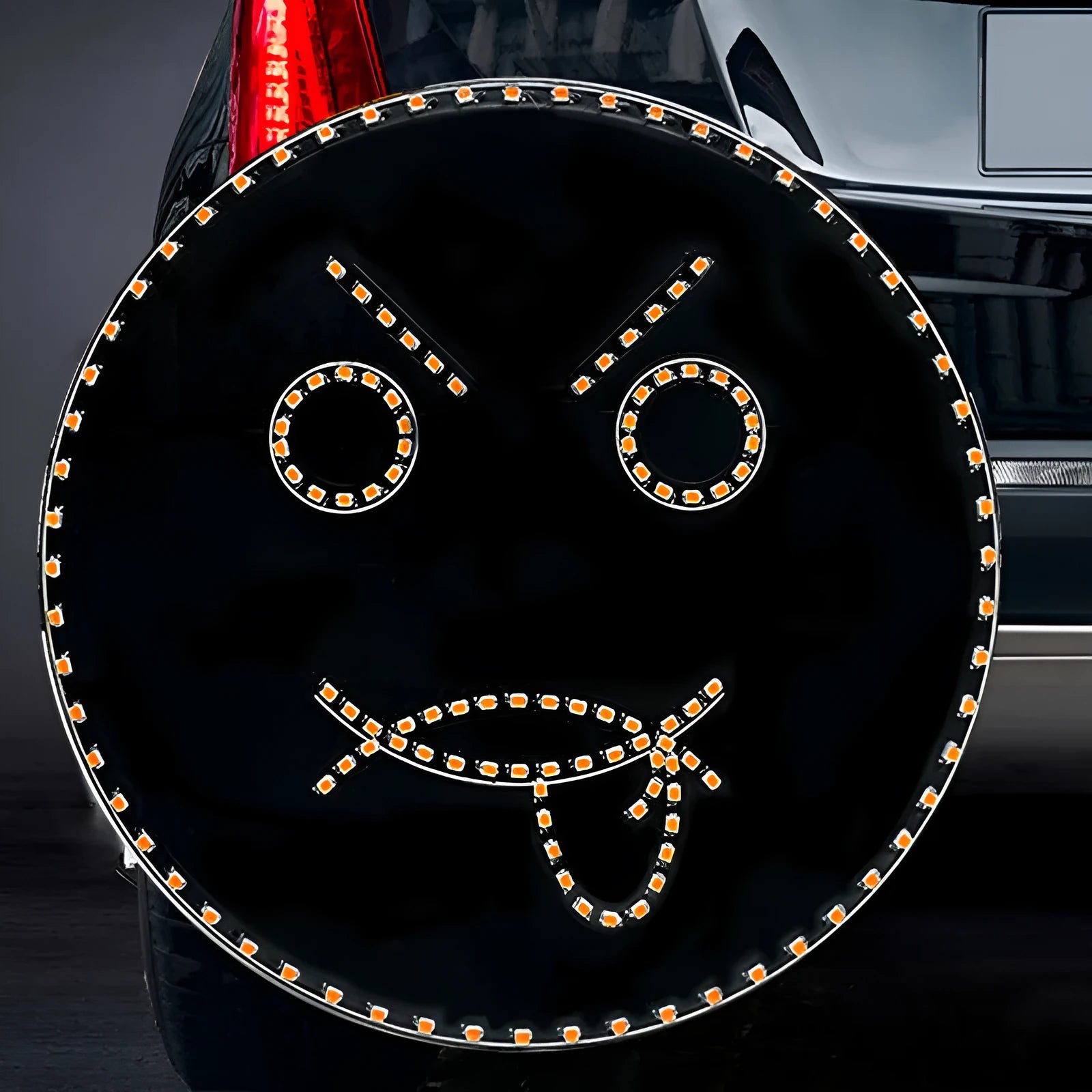 Black car rear window LED expression light showing smiley face pattern with orange illumination