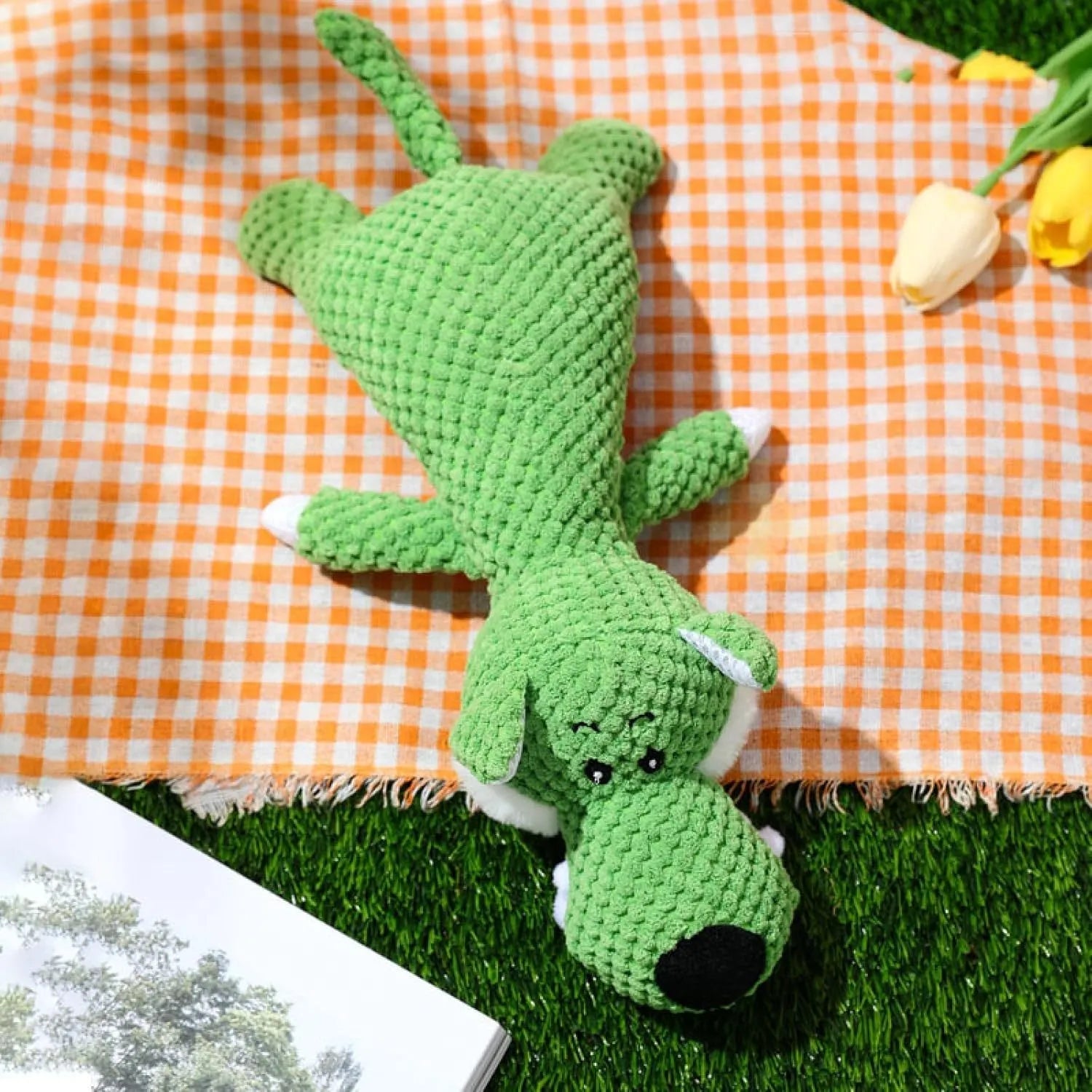 Green plush dog toy with corn kernel texture design for teeth cleaning, featuring squeaker inside