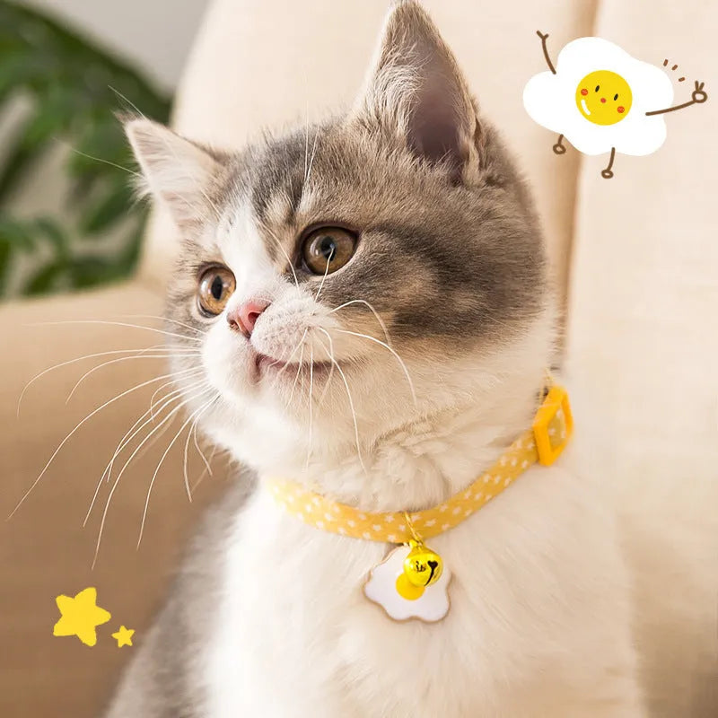 Adjustable cat collar with bell pendant and bow tie on small dog showing 17-33cm sizing range