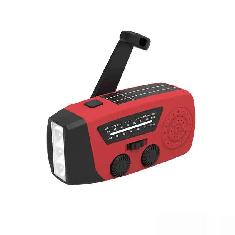 Red rechargeable handheld torch and radio with wrist strap and USB charging cable.