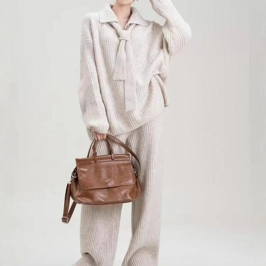 Dark grey sweater suit two-piece set with knit top and trousers showing collage stitching detail
