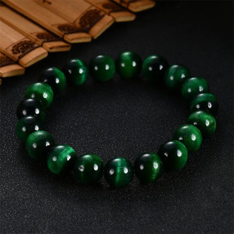 Green tiger eye stone bracelet with geometric beads in hand-polished finish showing natural colour banding