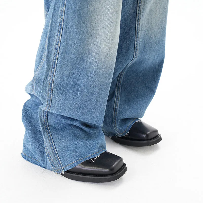 Light blue vintage washed wide leg denim jeans with a zipper fly on a mannequin.