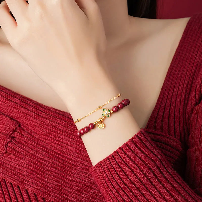 Women's geometric sterling silver bracelet with Ruyi, Xiangyun and red cinnabar flower detailing.