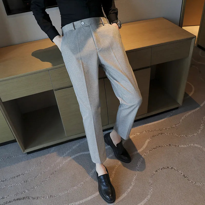Straight leg brown corduroy trousers with an elasticated waistband on a hanger.