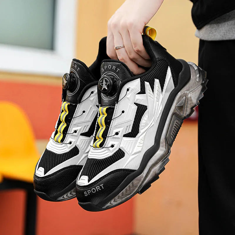 Men's black rotating button dad shoes with mesh upper and non-slip sole on wooden surface