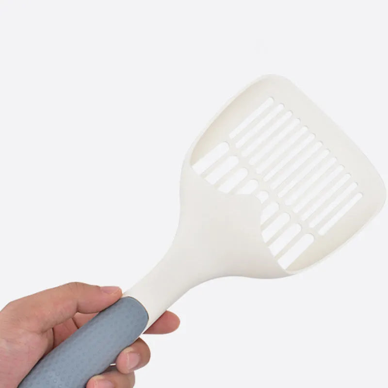 Large white plastic cat litter shovel with a slotted scoop head and handle.