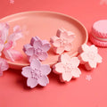 Pack of cherry blossom design student erasers on a desk, shown to leave no marks or debris.