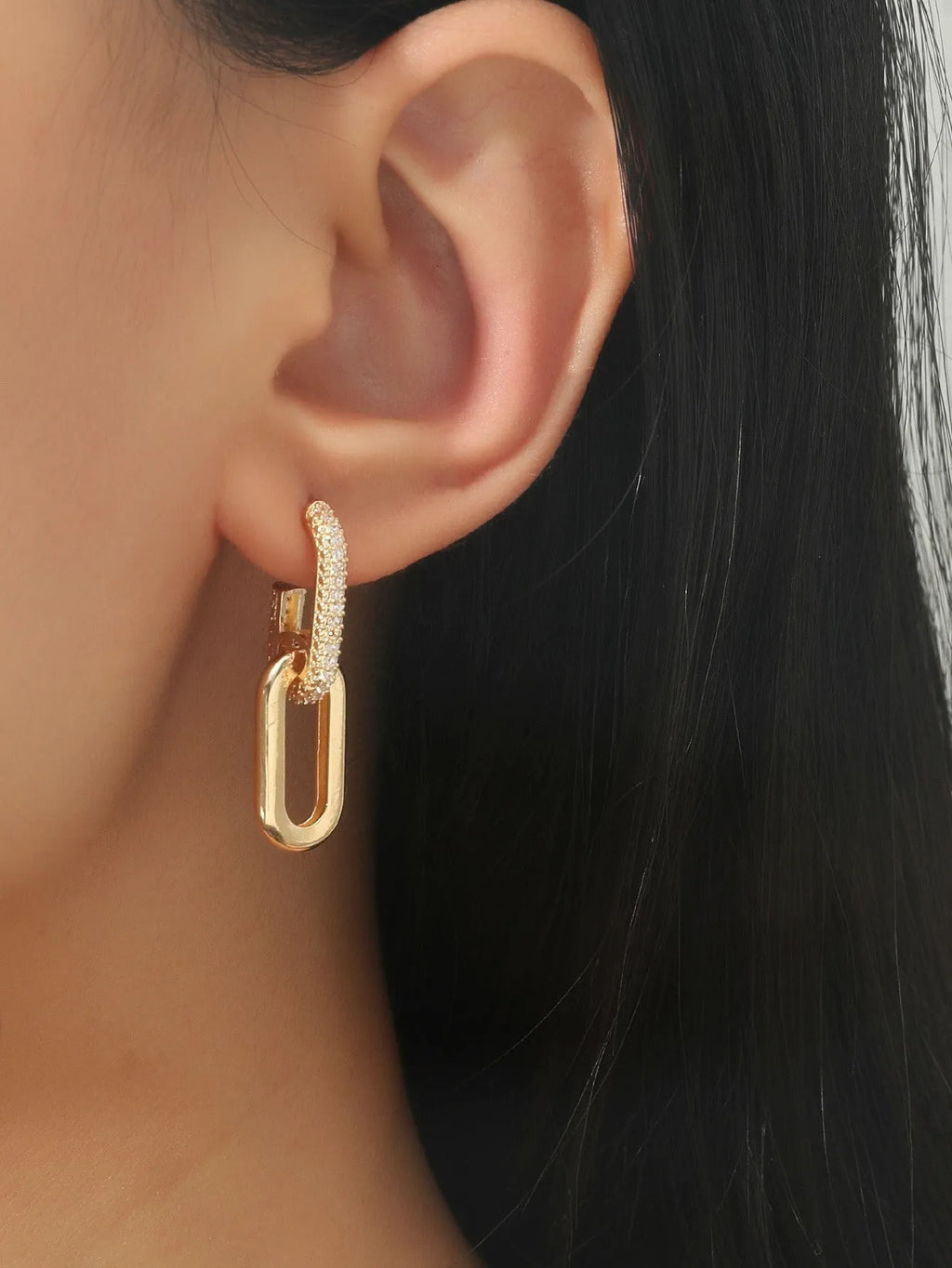 Pair of copper geometric ellipse earrings in 18K gold, silver, and rose gold finishes with diamond treatment