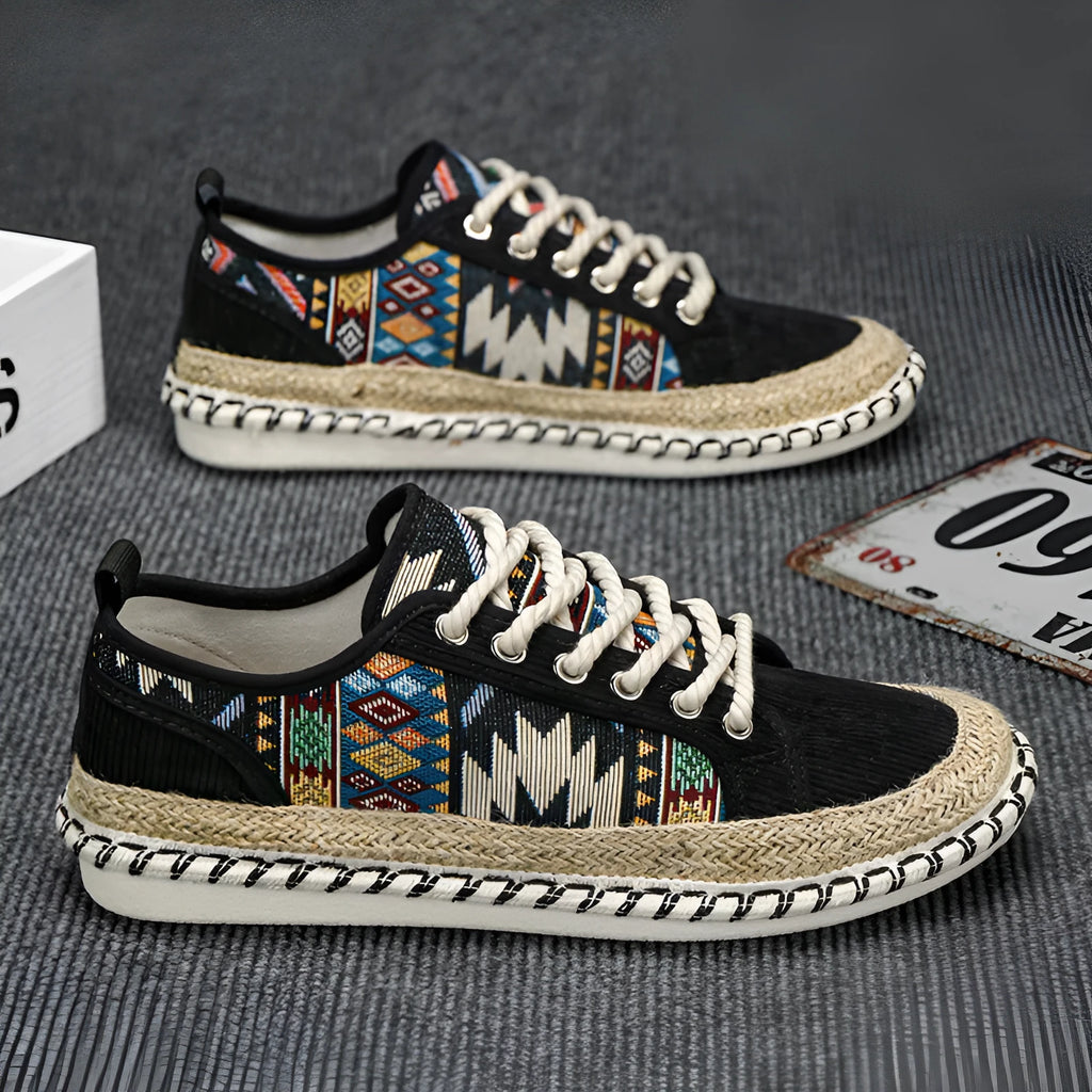 Men's round toe casual cloth shoes in beige and black on a plain background.