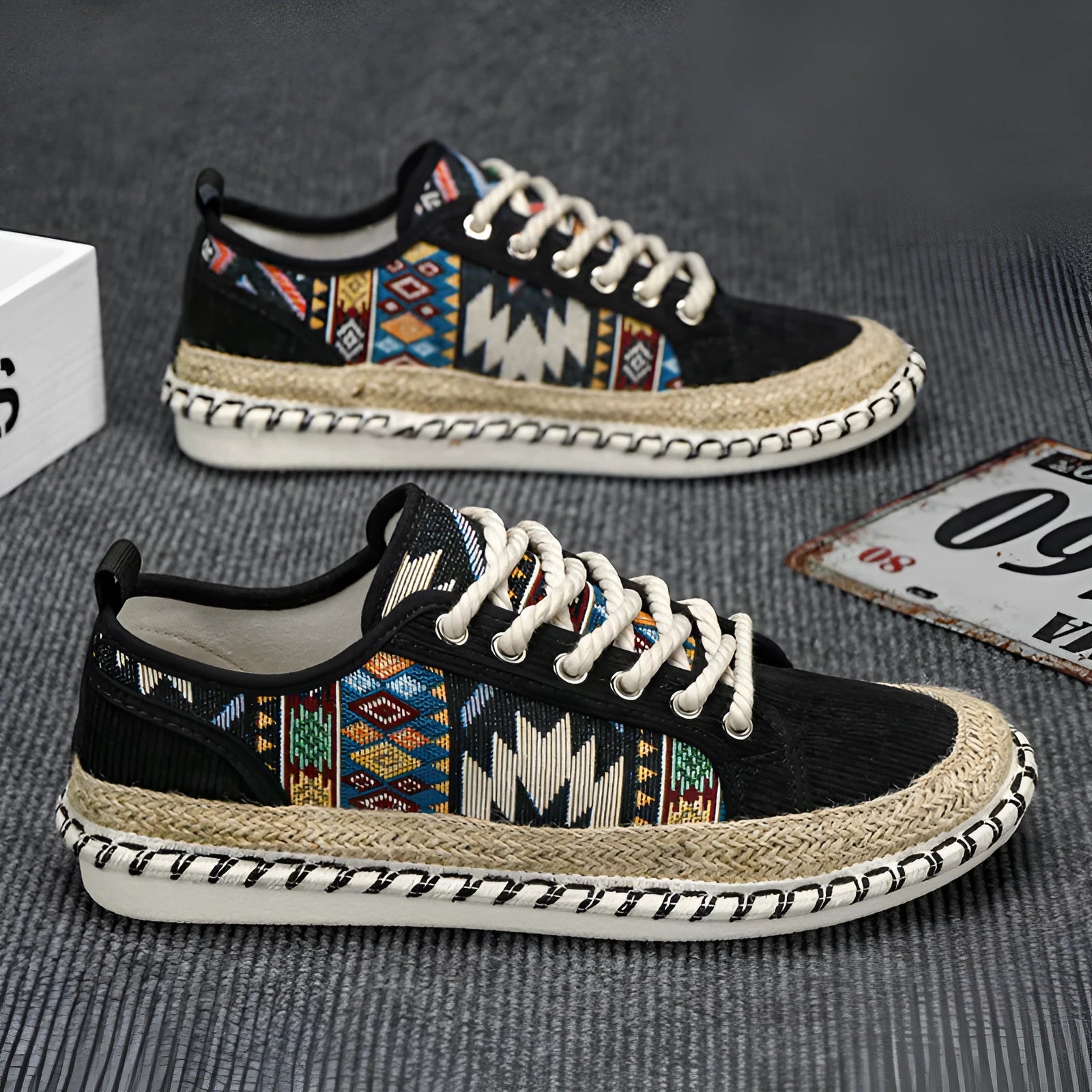 Men's round toe casual cloth shoes in beige and black on a plain background.