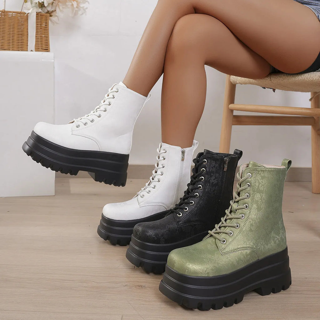 Women's black platform Martin boots with chunky heel and side zipper on a wooden floor