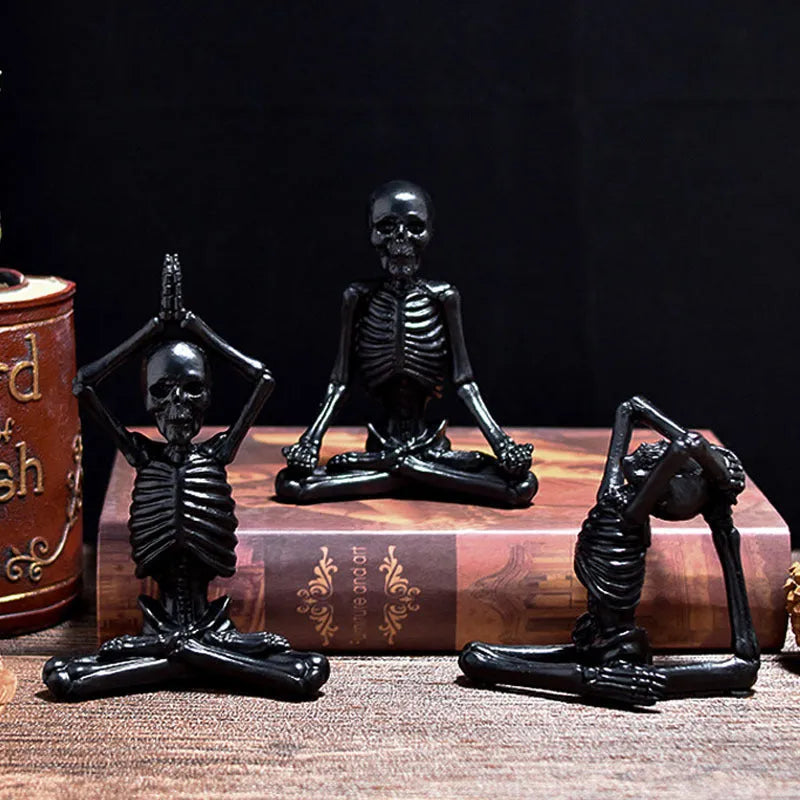 Hand-painted resin yoga pose skull skeleton ornament measuring 10.5-11cm wide on wooden desktop