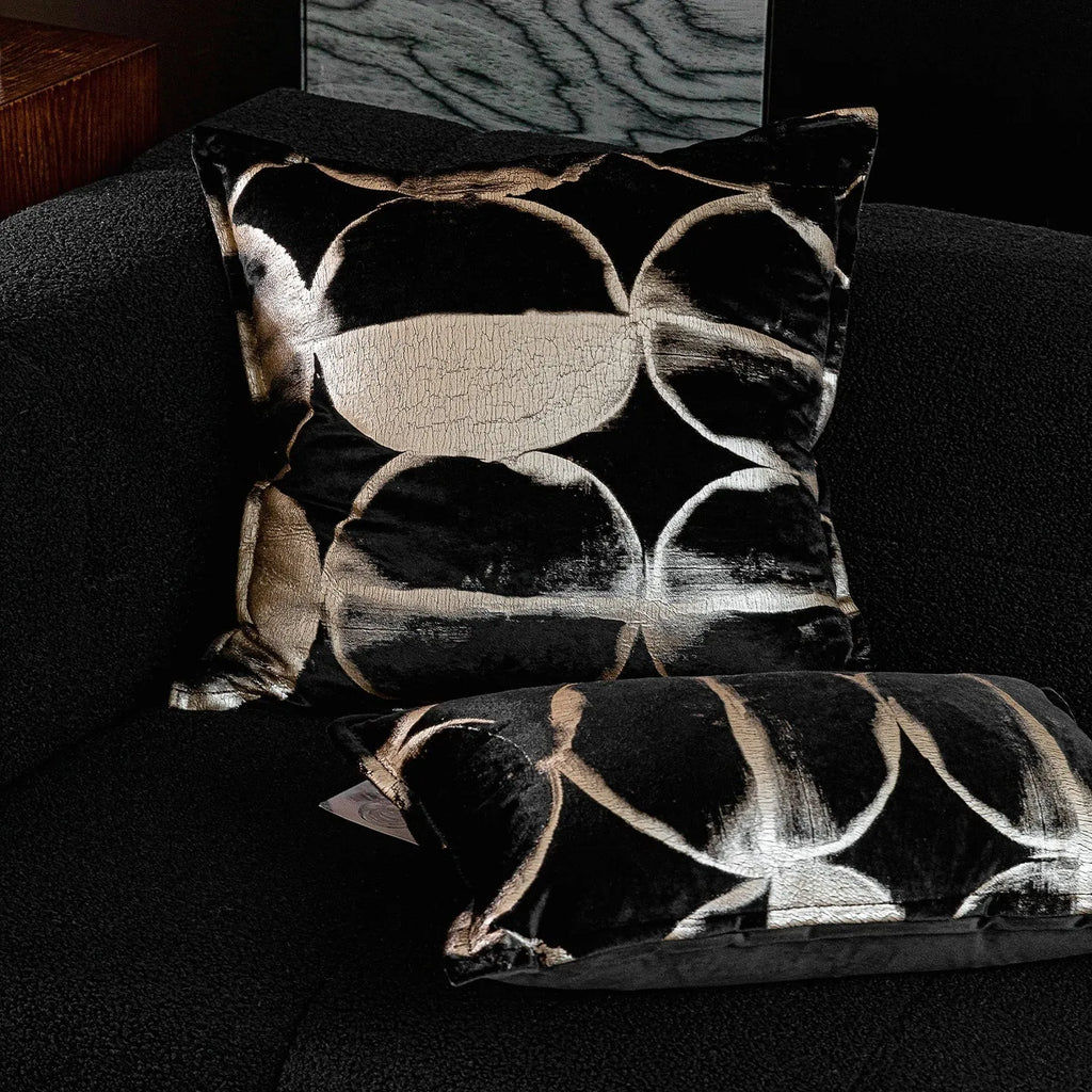 Black gold abstract pattern cushion with removable cover in three size options on furniture