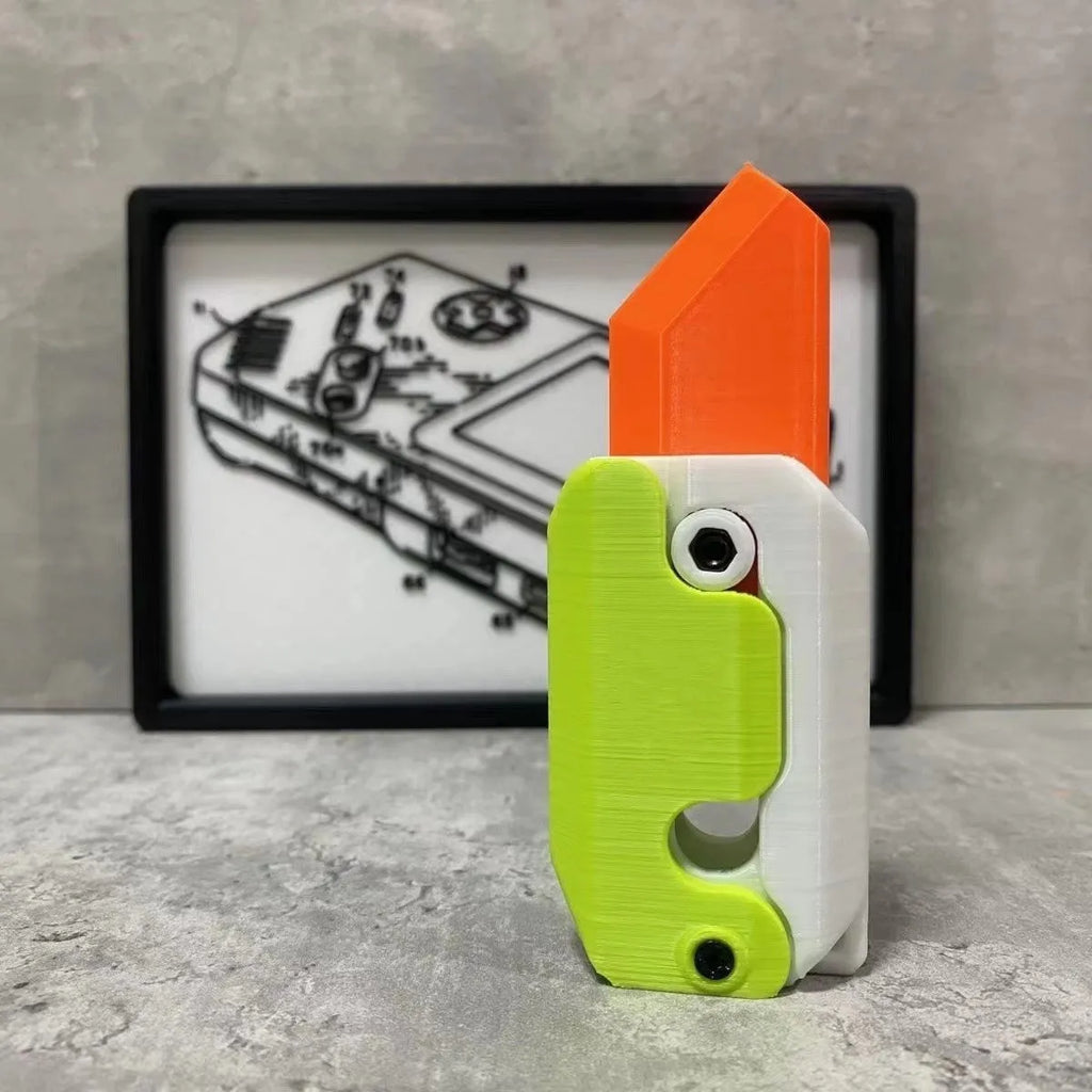 3D printed orange and green carrot-shaped gravity flick knife fidget toy on a white background.