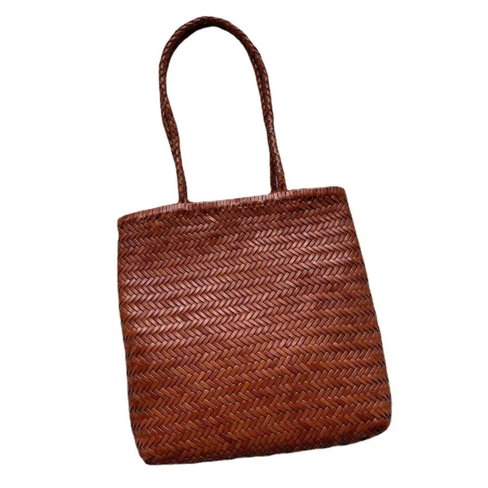 Brown woven leather tote bag with three-dimensional pocket, showing 27x30x6cm dimensions and handmade construction
