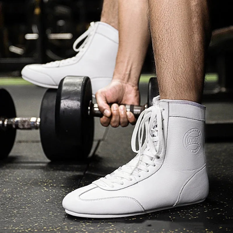 Professional black and gold mesh boxing shoes with leather upper and rubber sole.