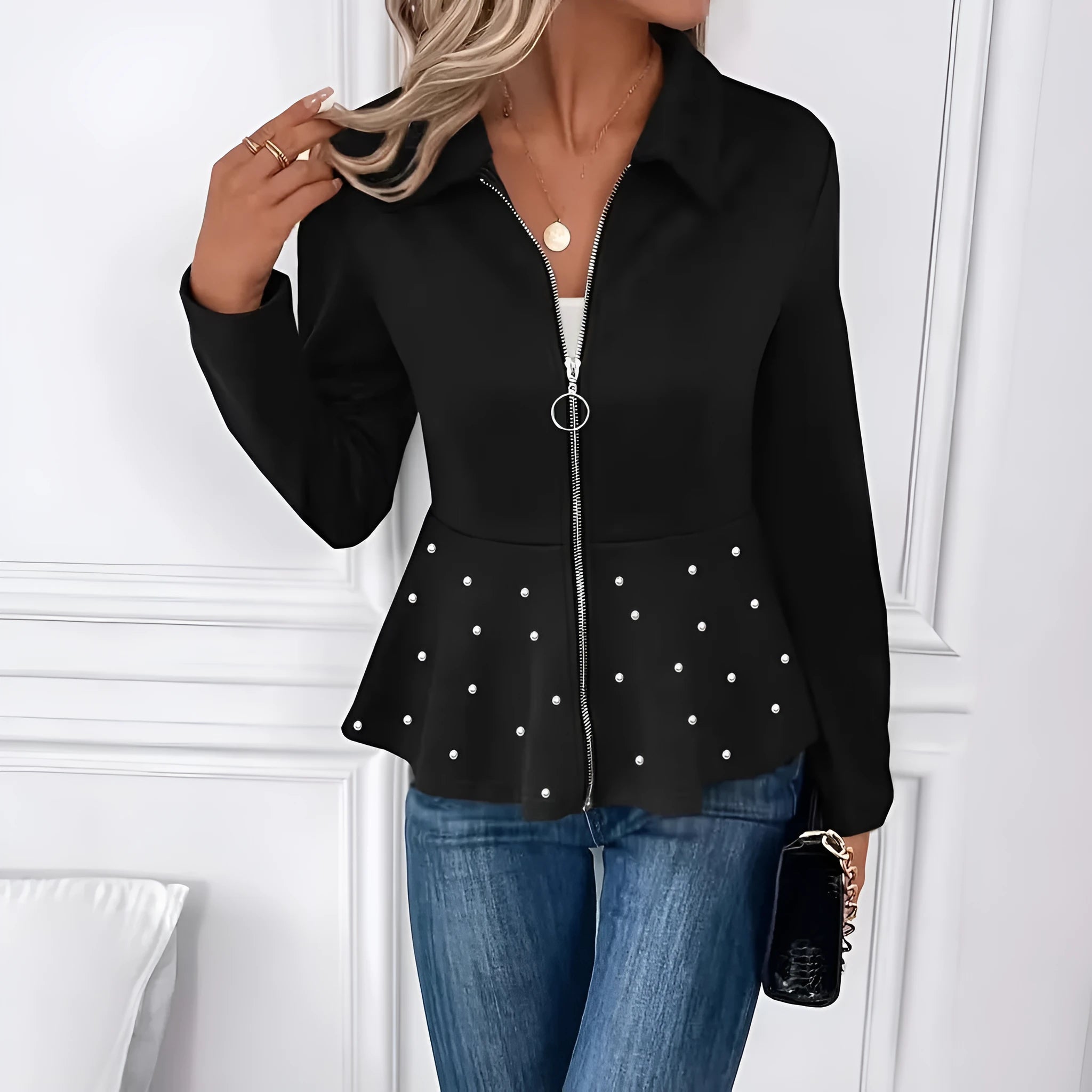 Women's loose-fit black coat with heavy-duty beaded zipper and ruffled hem, long sleeves.