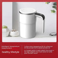 White electric stirring mug with LCD temperature display and magnetic stirrer base