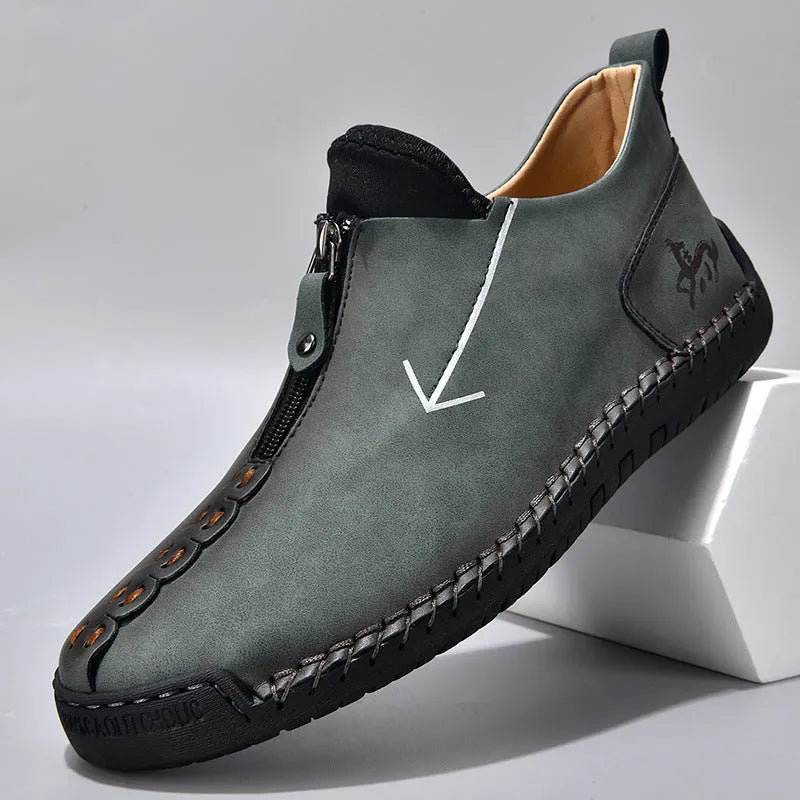 Men's black leather boots with front zipper, hand-stitched sole, and mid-calf length