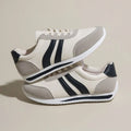 Blue and red low-top lace-up running sneakers with a round toe and rubber sole