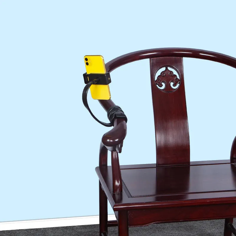 Flexible silicone and aluminium adjustable hose phone holder bent into an S-shape with smartphone attached.