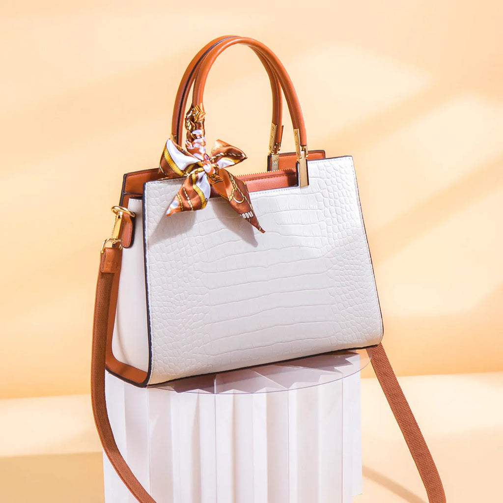 Women's milky white shoulder handbag with three interior compartments showing zipper changing bag, mobile phone pocket, and document storage
