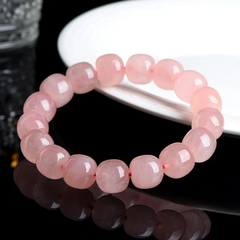 Natural pink crystal barrel bead bracelet with 19 pieces measuring 8-10mm, geometric design on wrist