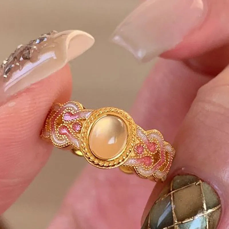 Pink crystal enamel ring with geometric design and adjustable open mouth on a copper base