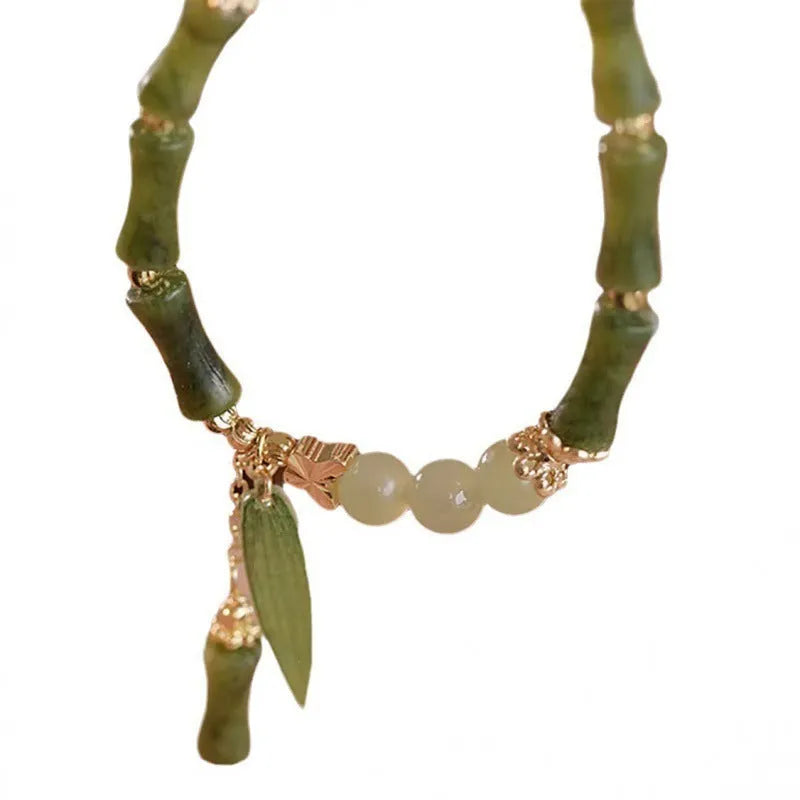 Chinese style bamboo leaf bracelet for women in glass with bamboo joint elements, showing manual processing and colour variations