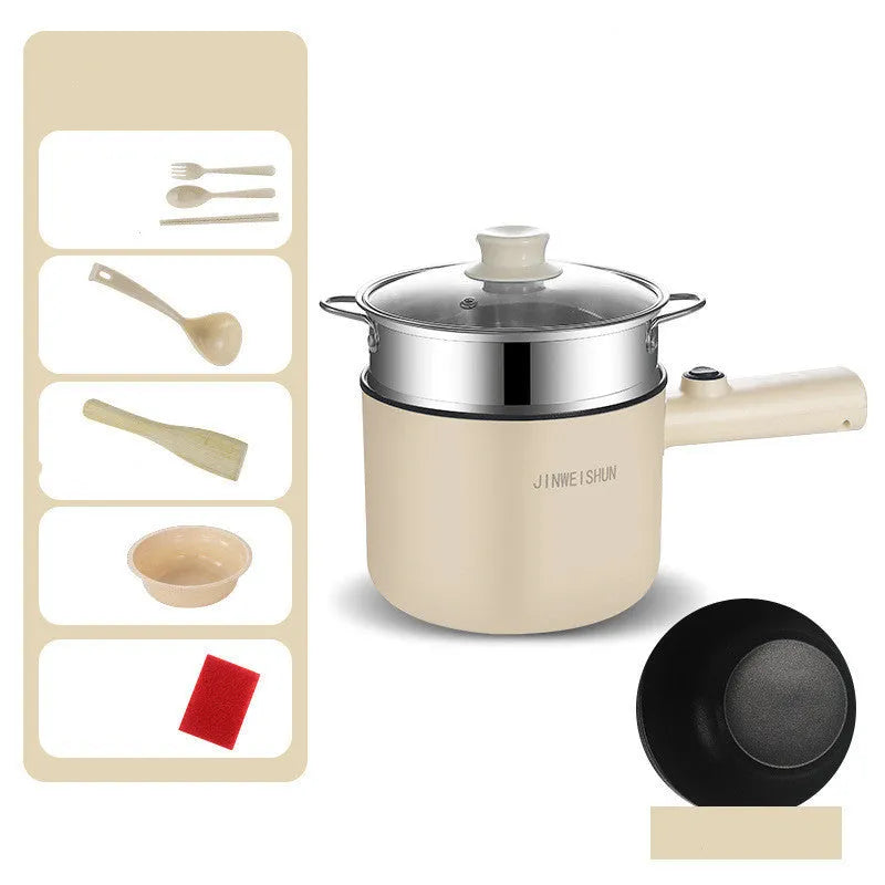 White and green mini electric hot pot cooker with stainless steel body and cooking accessories on a kitchen counter.